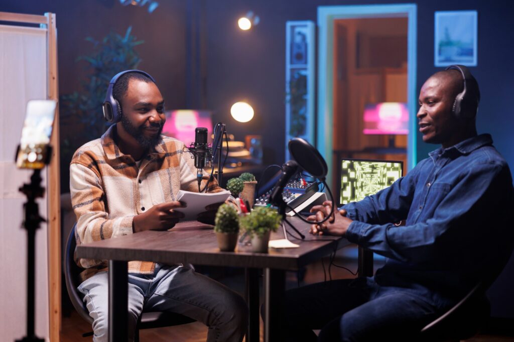 Two men recording a podcast for social media oversharing hot takes on topics.