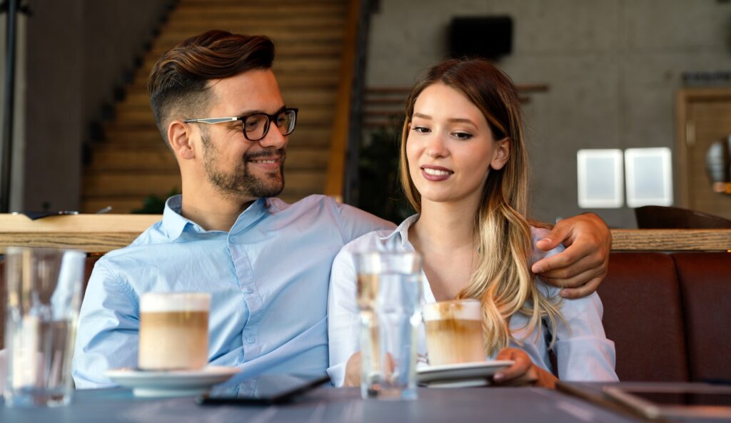 A woman and a man sitting together on a date discussing emotional oversharing.